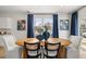 Bright dining area with hardwood floors, a round table, art, and light gray chairs at 2815 Habibi Ct, Buford, GA 30519