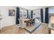 The dining area features a modern table and chairs, blue curtains, and bright windows at 2815 Habibi Ct, Buford, GA 30519