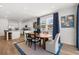 The dining area features a modern table and chairs, blue curtains, and views of the kitchen at 2815 Habibi Ct, Buford, GA 30519