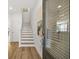 Inviting entryway with wood floors, staircase, and an art piece at 2815 Habibi Ct, Buford, GA 30519