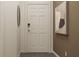 Hallway with modern decor, featuring a stylish door, framed artwork, and an elegant round mirror at 2815 Habibi Ct, Buford, GA 30519