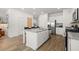 Modern kitchen features a center island with breakfast bar, stainless steel appliances, and white cabinetry at 2815 Habibi Ct, Buford, GA 30519
