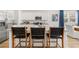 Beautiful kitchen island features a breakfast bar with stylish chairs, stainless steel appliances, and granite counters at 2815 Habibi Ct, Buford, GA 30519