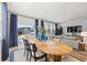 Light-filled living and dining space with a modern table, couch and sliding glass doors at 2815 Habibi Ct, Buford, GA 30519