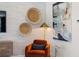 Corner of a living room with comfortable orange arm chair, media center, and woven wall art at 2815 Habibi Ct, Buford, GA 30519