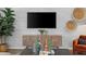 Cozy living room with a neutral sofa, black coffee table, media center, and woven wall art at 2815 Habibi Ct, Buford, GA 30519