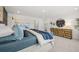 Sunlit main bedroom featuring an accent wall, dresser, and calming decor at 2815 Habibi Ct, Buford, GA 30519