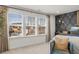 Well-lit main bedroom with large windows, accent wall, and cozy armchairs at 2815 Habibi Ct, Buford, GA 30519