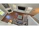 Birds-eye view of living room with tall windows, fireplace, and comfortable seating arrangement at 5465 Mountain Top Pl, Cumming, GA 30041