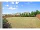 Spacious backyard with a well-maintained lawn and a wooden fence at 5760 Palmtree Pass, Cumming, GA 30040