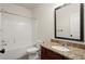 Bathroom with a granite vanity, framed mirror, tub, and shower at 5760 Palmtree Pass, Cumming, GA 30040