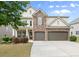 Beautiful two-story home featuring stone accents, a two-car garage, and a well-manicured lawn at 5760 Palmtree Pass, Cumming, GA 30040