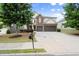 Charming two-story home with a well-maintained lawn, mature trees, and a spacious driveway at 5760 Palmtree Pass, Cumming, GA 30040