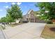 Charming home with a stone facade, three-car garage and well-manicured lawn at 5760 Palmtree Pass, Cumming, GA 30040