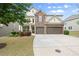 Beautiful house with brick accents, lush landscaping and a driveway at 5760 Palmtree Pass, Cumming, GA 30040