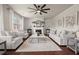 Open-concept living room with a fireplace, hardwood floors, and ample natural light at 5760 Palmtree Pass, Cumming, GA 30040