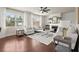 Spacious living room featuring hardwood floors, fireplace and large windows at 5760 Palmtree Pass, Cumming, GA 30040