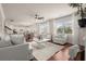 This open concept living area has hardwood floors, natural light, and an inviting seating arrangement at 5760 Palmtree Pass, Cumming, GA 30040