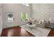 Bright living room with a modern sofa, large windows, and an open floor plan at 5760 Palmtree Pass, Cumming, GA 30040