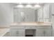 Bright bathroom featuring a dual vanity, large mirror and ample cabinet space at 1440 Sandford Sw Trl, Lilburn, GA 30047