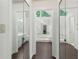Bright bathroom hallway leading to vanity, large tub and skylight at 1440 Sandford Sw Trl, Lilburn, GA 30047