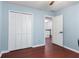 Clean bedroom with hardwood floors, a ceiling fan and a closet at 1440 Sandford Sw Trl, Lilburn, GA 30047