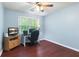 Bedroom featuring hardwood floors, ceiling fan and ample sunlight at 1440 Sandford Sw Trl, Lilburn, GA 30047