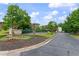 Rivermist welcome sign surrounded by mature trees and well maintained landscaping at 1440 Sandford Sw Trl, Lilburn, GA 30047