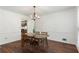 Dining room with hardwood floors, chandelier, and classic wainscoting at 1440 Sandford Sw Trl, Lilburn, GA 30047