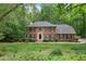Charming brick home featuring a well-manicured front yard and mature trees at 1440 Sandford Sw Trl, Lilburn, GA 30047