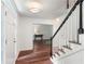 Inviting foyer with staircase and hardwood floors, offering a welcoming entrance at 1440 Sandford Sw Trl, Lilburn, GA 30047