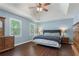 Spacious main bedroom featuring tray ceilings, natural light, and beautiful hardwood flooring at 1440 Sandford Sw Trl, Lilburn, GA 30047