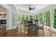 Bright sunroom with large windows, hardwood floors, and a dining set at 1440 Sandford Sw Trl, Lilburn, GA 30047