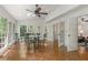 Bright sunroom with large windows, hardwood floors, and a dining set at 1440 Sandford Sw Trl, Lilburn, GA 30047