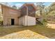 Rear view of home with lower level entrance, screened porch and stairs at 2004 Poplar Falls Rd, Lithonia, GA 30058
