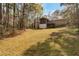View of the expansive back yard behind this two-story home featuring a raised deck at 2004 Poplar Falls Rd, Lithonia, GA 30058