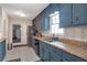 Traditional kitchen with blue cabinets, tile floors, and modern appliances at 2004 Poplar Falls Rd, Lithonia, GA 30058