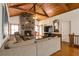 Cozy living room with wood-beamed ceilings, stone fireplace, and hardwood floors at 2004 Poplar Falls Rd, Lithonia, GA 30058