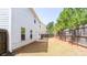 Backyard with a wood privacy fence, a small patio, and a well-maintained lawn at 2352 Allman Dr, Jonesboro, GA 30236