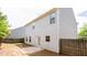 Large backyard with a wood privacy fence, a concrete patio, and views of the home's exterior at 2352 Allman Dr, Jonesboro, GA 30236