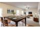 Elegant dining area with a large table, stylish chairs, modern lighting, and seamless flow to the living area at 2352 Allman Dr, Jonesboro, GA 30236