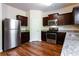 Modern kitchen featuring stainless steel appliances, granite countertops, ample cabinet space, and hardwood floors at 2352 Allman Dr, Jonesboro, GA 30236