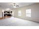 Spacious living area with hardwood floors, and view to the kitchen with modern appliances and dark cabinetry at 2352 Allman Dr, Jonesboro, GA 30236