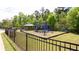 Fenced-in community playground with play structure, picnic shelter, and benches at 2352 Allman Dr, Jonesboro, GA 30236