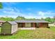 Backyard with shed, paved area, and brick house at 3050 Rebecca Sw Dr, Atlanta, GA 30311