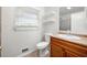 Bathroom featuring a modern toilet, vanity with a sink, and decorative shelving at 3050 Rebecca Sw Dr, Atlanta, GA 30311