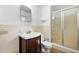 Bathroom with vanity, toilet and tiled shower with glass doors at 3050 Rebecca Sw Dr, Atlanta, GA 30311