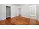 Cozy bedroom features hardwood floors, closet, and view into bathroom at 3050 Rebecca Sw Dr, Atlanta, GA 30311