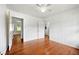 Bedroom showcasing light-colored walls, hardwood floors, and an opening to another room at 3050 Rebecca Sw Dr, Atlanta, GA 30311