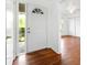 Bright foyer with hardwood floors, a white front door with glass, and a glimpse into the living area at 3050 Rebecca Sw Dr, Atlanta, GA 30311